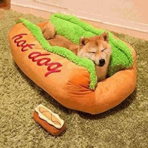 Shiba Inu sleeping in the hot dog shaped pet bed with lettuce trim and a matching plush toy